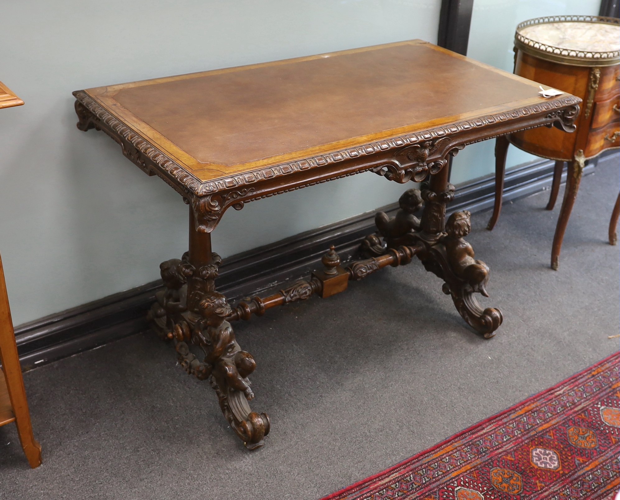 A late 19th century rectangular continental carved walnut centre table with cherub underframe, width 106cm, depth 60cm, height 71cm